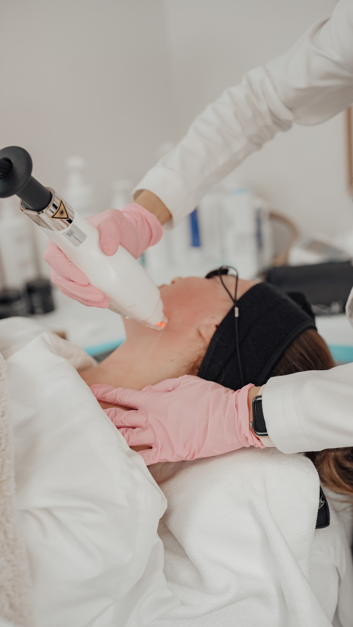 Provider treating a client's face with the Lutronic Ultra laser for sun damage at Skin With Bea Esthetics in Scottsdale
