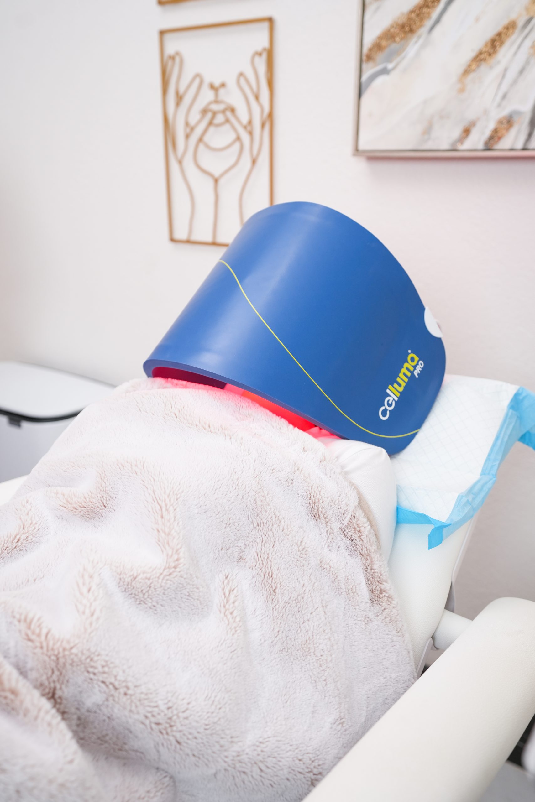 Celluma Pro LED light therapy panel over a client's face after a treatment at Skin With Bea Esthetics in Scottsdale