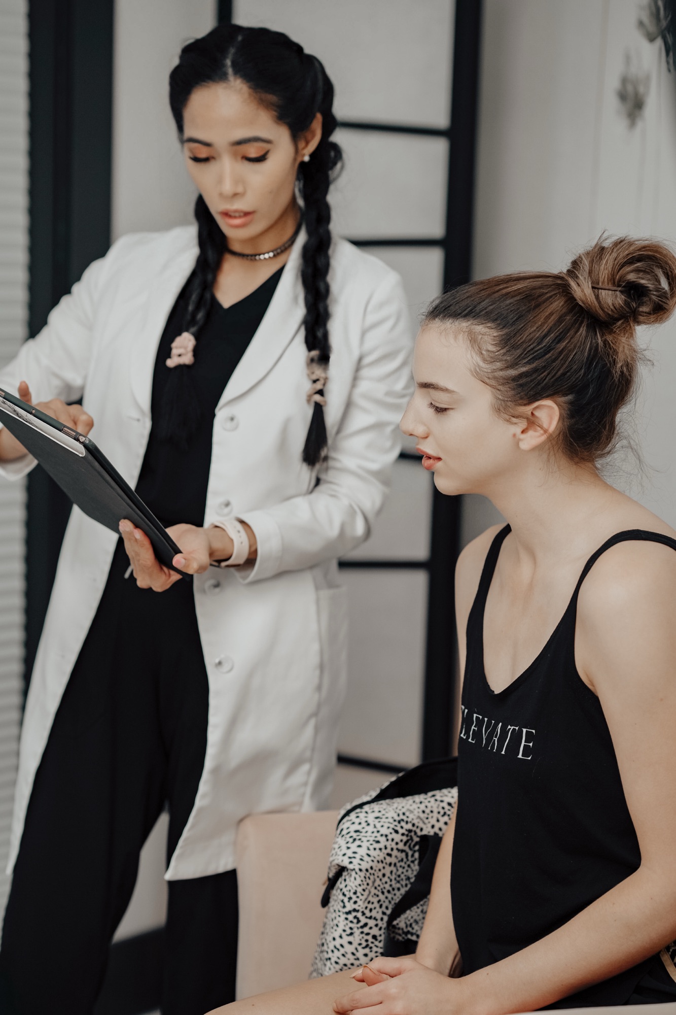Registered nurse performing a skin consultation with a client at Skin With Bea Esthetics – personalized skincare guidance in a professional medspa setting
