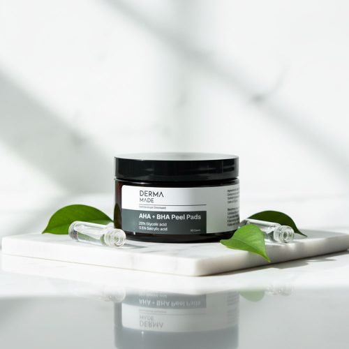 Derma Made AHA + BHA Peel Pads on Marble Surface Derma Made AHA + BHA Peel Pads displayed on white marble, showcasing professional skincare packaging with clean and fresh lighting.