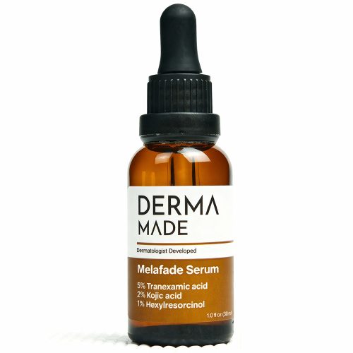 Derma Made Melafade Serum bottle with white and magenta label, formulated with Tranexamic Acid, Kojic Acid, and Hexylresorcinol to fade dark spots and melasma.