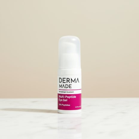 Derma Made Multi-Peptide Eye Gel – Anti-Aging Eye Treatment with 10% Peptides Derma Made Multi-Peptide Eye Gel bottle on a white marble counter with a soft beige background. The 3-inch eye cream product is photographed in a clean, minimalist setting with natural daylight.