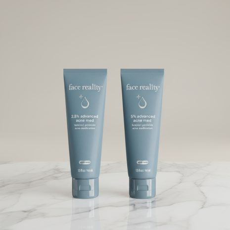 Face Reality Acne Med 2.5% and 5% Benzoyl Peroxide Treatment High-quality product photo of Face Reality Acne Med 2.5% and 5% Benzoyl Peroxide acne treatments standing side by side on a marble surface. Dermatologist-developed formulas designed to clear acne and prevent breakouts.