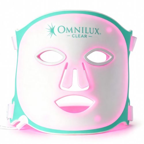Omnilux Clear LED Mask glowing pink, designed to treat acne and inflammation using blue and red light therapy. Available at Skin With Bea Esthetics in Scottsdale, Arizona.