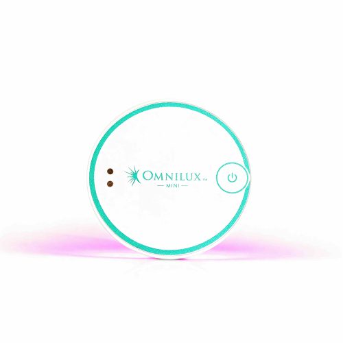 Omnilux Mini Blemish Eraser LED device for acne treatment shown glowing with therapeutic light