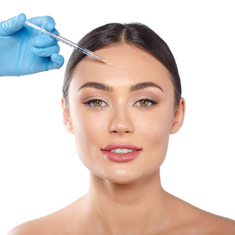 Portrait of an attractive young woman receiving botox treatment.